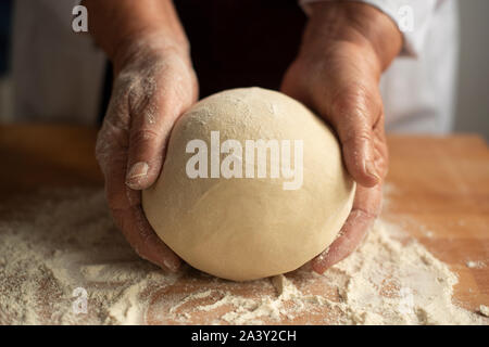 Artisan baker kneading sourdough bread- close-up Stock Photo