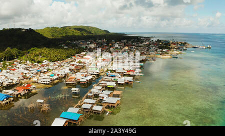 Fishing Village of stilt houses built over the sea, top view. Dapa, Siargao, Philippines. Stock Photo