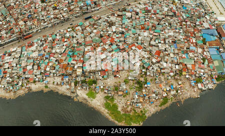 Slums in Manila near the port. River polluted with plastic and garbage. Manila, Philippines. Stock Photo