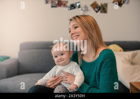 Blonde young mother together with her baby girl
