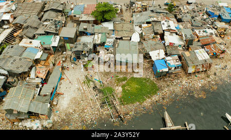 Slums in Manila near the port. River polluted with plastic and garbage. Manila, Philippines. Stock Photo