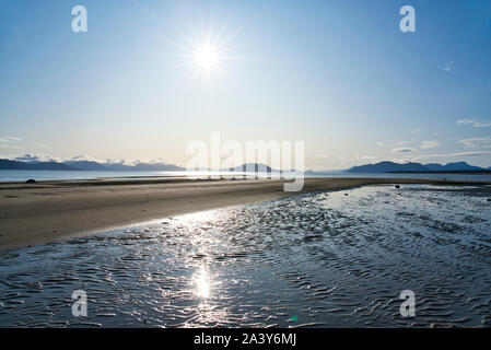 Beautiful sunny day at  the beach in Gustavus Alaska with a sunburst. Stock Photo
