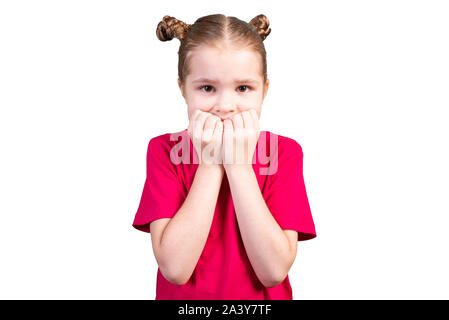 The girl bites her nails and got scared. Isolated on a white background. Stock Photo