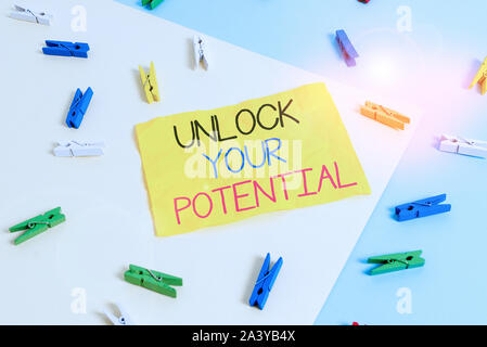 Handwriting text writing Unlock Your Potential. Conceptual photo improve self awareness Skills to Achieve more Colored clothespin paper empty reminder Stock Photo