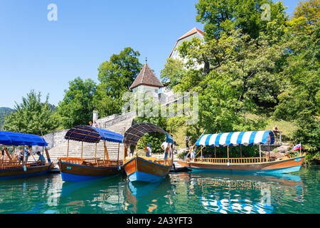 Traditional wooden Pletna boats docked on Bled Island, Lake Bled, Bled, Upper Carniola Region, Slovenia Stock Photo