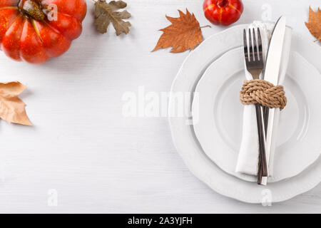 Thanksgiving autumn table setting with decorative pumpkins and dried leaves copy space Stock Photo