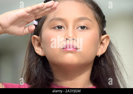 Saluting Cute Filipina Girl Stock Photo
