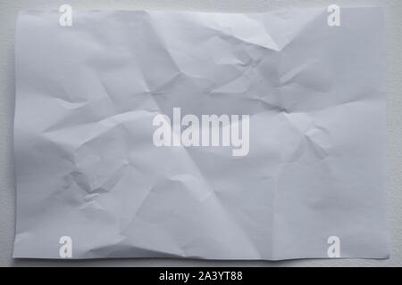 wrinled up white sheet of paper with creases and folds background Stock Photo