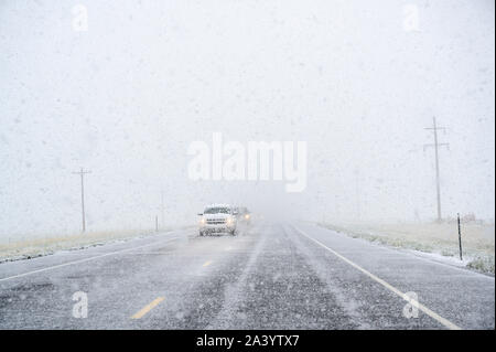 View through windscreen of car on highway during snow Stock Photo