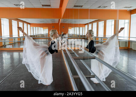 Ballet dancer practicing at barre Stock Photo