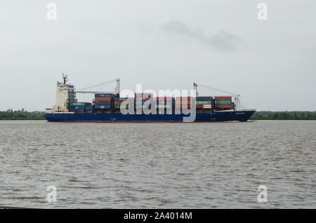 Container ship transiting through the Magdalena River in Barranquilla Stock Photo