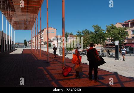PASSENGERS IN FRONT OF THE PERPIGNAN TRAIN STATION, THE CENTER OF THE WORLD FOR SALVADOR DALI, PERPIGNAN (66), FRANCE Stock Photo