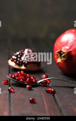 Ripe pomegranates isolated on dark background. Stock Photo