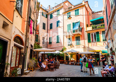 Monterosso Al Mare, Italy - September 02, 2019: People are sitting in restaurant and bars on the cozy streets in Monterosso Al Mare, Cinque Terre, Ita Stock Photo