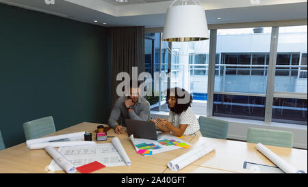 Two young creative professionals working together in a modern office Stock Photo
