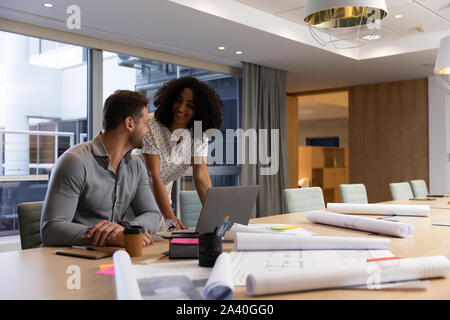 Two young creative professionals working together in a modern office Stock Photo