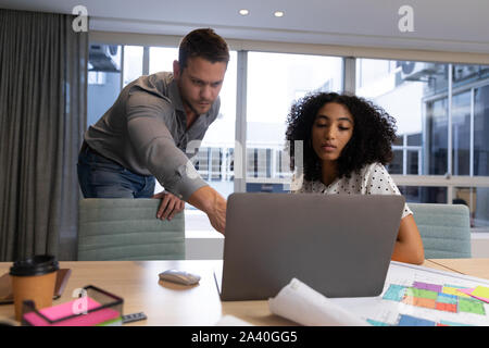 Two young creative professionals working together in a modern office Stock Photo