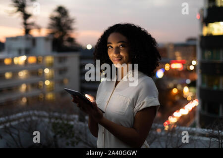 Portrait of young female professional working on office roof terrace Stock Photo