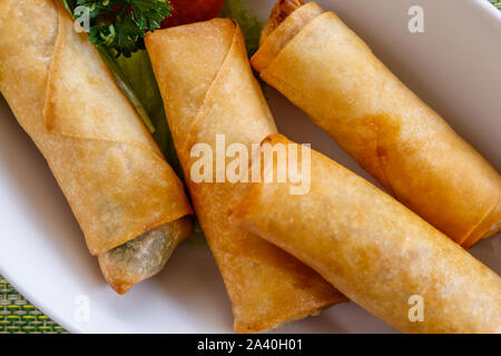 Vietnamese fried spring rolls on a white ceramic plate. Top view. Stock Photo