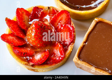 Mini Strawberry tart and Salted caramel tart. Top view. Stock Photo