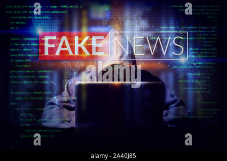 hacker working on a computer laptop, double exposure with screen of fake news. manipulated content on internet . anonymous face Stock Photo