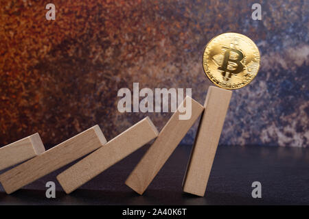 bitcoin falling down from domino blocks Stock Photo