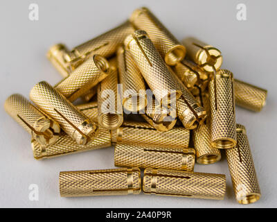 Heap of shiny metal studs over white background Stock Photo