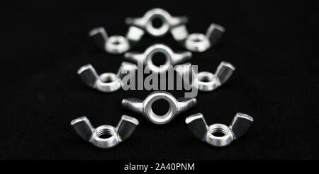 Wing nuts arranged in triplets Stock Photo