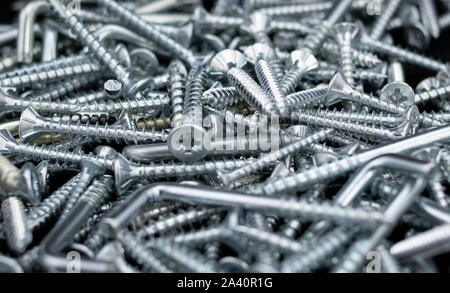 Heap of screws in the foreground Stock Photo
