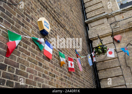 The flags of many nations hang untidily outside the Royal Oak pub, on 3rd October 2019, in Dartford, Kent, England. Voters in Dartford voted 64% in favour of Brexit during the 2016 referendum. Stock Photo