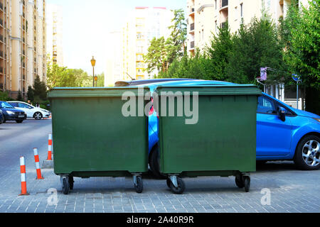 Dustbins being full with garbage. Garbage is pile lots dump. Garbage bins in sunny city. Stock Photo