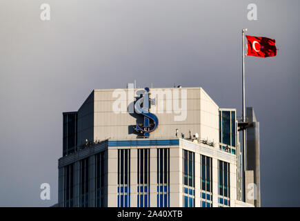 Close up of the logo of Isbank with a Turkish flag at the rooftop of tallest building of Is Towers Complex. Stock Photo