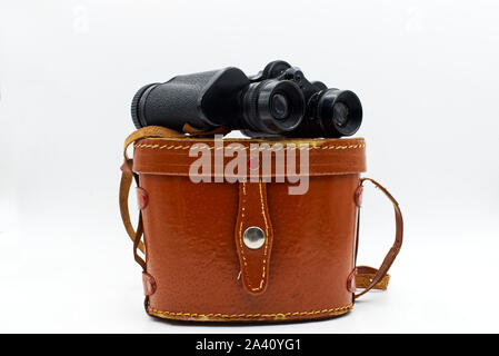 Ancient binoculars with its leather bag cover, isolated on white background Stock Photo