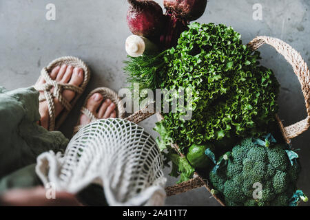 Grocery bags full of fresh vegetables and greens Stock Photo