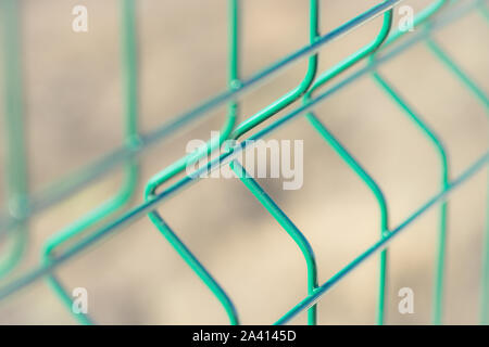 New green grid fence close up. Perspective view. Selective focus Stock Photo