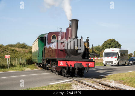 Le Crotoy, Chemin de Fer de la Baie de Somme, (CFBS), train crossing main road Stock Photo