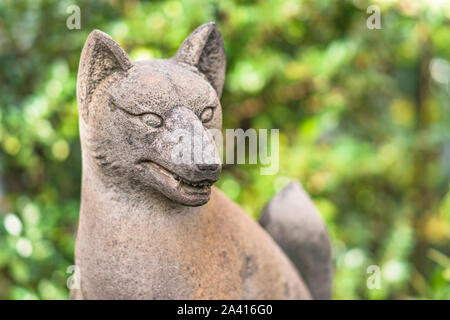 Statue of foxes inari, deity of rice in the Shinto shrine of Mejiro Toyosaka Inari Jinja in Tokyo. Stock Photo