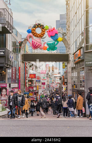 Portal decorated with colorful inflatable balloons motifs at the entrance to Takenoshita Street, popular with young Japanese high school students and Stock Photo