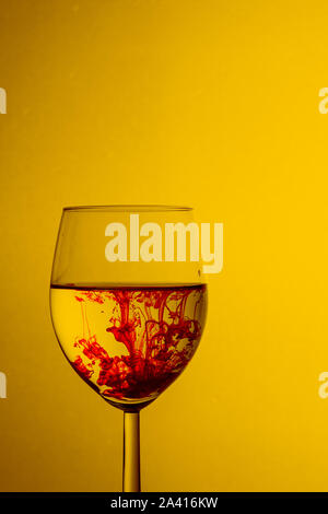 Paint swirling in water. Splashes of paint in a glass Stock Photo