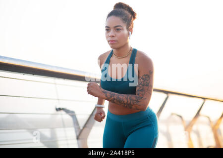 Dark-eyed woman feeling motivated while running every day Stock Photo