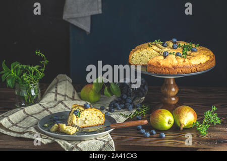 Delicious dessert blueberry tart with fresh berries and pears, sweet tasty cheesecake, berry pie. French cuisine Artistic Still Life in the style of D Stock Photo