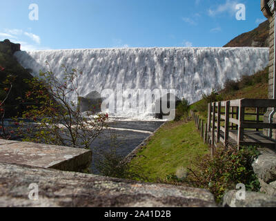 Caban Coch dam in the Elan Valley in full flow after the heavy rainfall of October 2019 Stock Photo