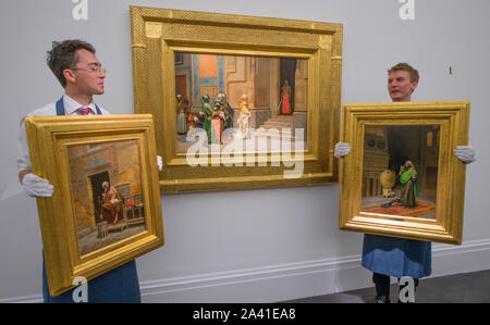 Sotheby‘s, New Bond Street, London, UK. 11th October 2019. Sotheby’s Orientalist & Middle Eastern Week encompasses important works from the Najd Collection, The Shakerine Collection, 20th Century Art/Middle East, and Arts of the Islamic World before the sales on 22 & 23 October. Image (centre): Rudolf Ernst. The New Bride, estimate £400,000-600,000; (left): Ludwig Deutsch. The Scribe, estimate £800,000-1,200,000; (right): Ludwig Deutsch. The Morning Prayer, estimate: £700,000-1,000,000. Credit: Malcolm Park/Alamy Live News. Stock Photo