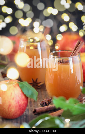 Fresh apple cider drink with star of anise and cinnamon. Selective focus on juice with extreme blurred background and foreground. Stock Photo