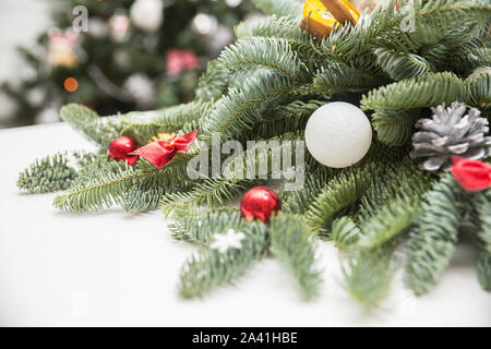 Christmas decorations, fir branches decorated with balls, cones, bows and snowflakes Stock Photo