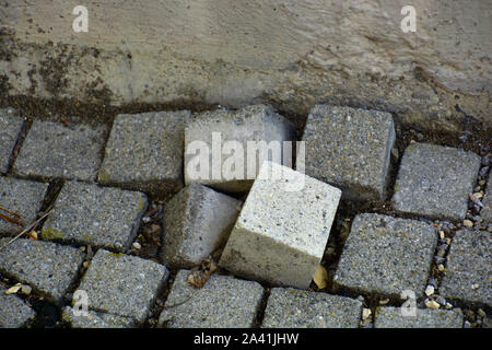 uneven cobble stones in vintage paving, bumpy paving stone surface of walkway Stock Photo