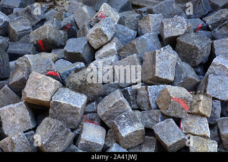 heap of Paving stones On a construction site, old cobble stones with red marker on it Stock Photo