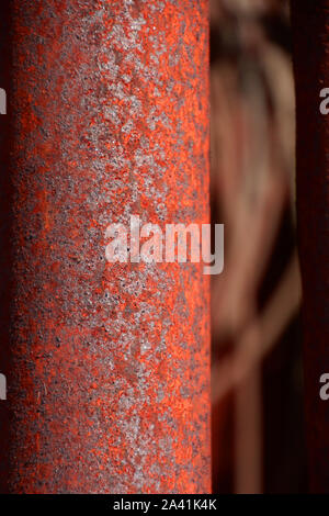 macro of a corroded textured vintage rusty metal pole, rusty metal pole close-up lit by the sun Stock Photo