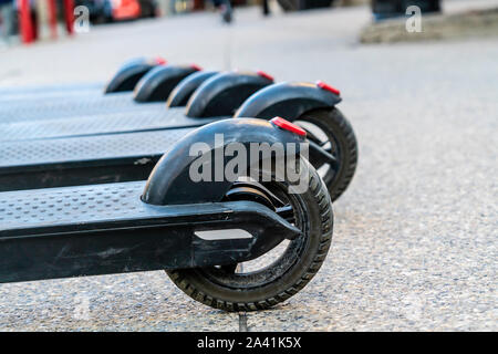 Electric Scooter wheels on a city pavement Stock Photo