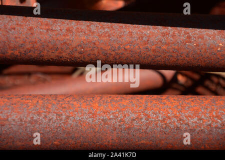 rusty metal pole close-up lit by the sun, macro of rusty corrode metal bars Stock Photo